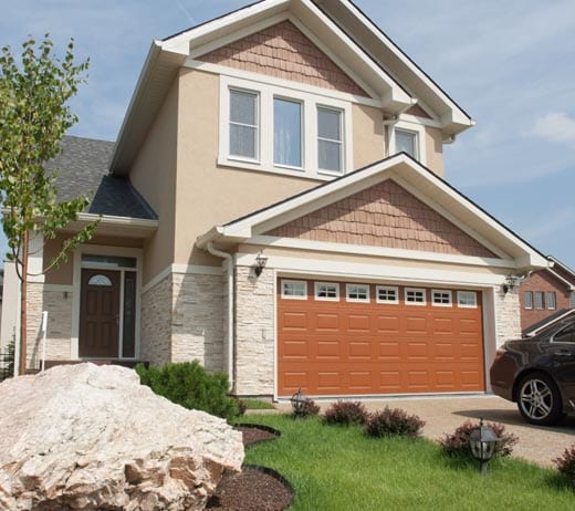 Southern Quality Company | Tan house with orange garage door and a new shingled roof